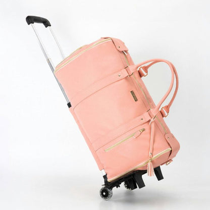 Sac de voyage rose monté sur roulettes, poignée télescopique sortie