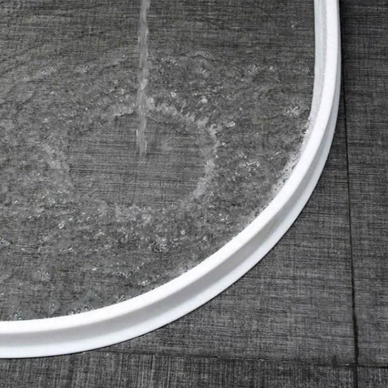 L'eau de la douche reste contenue derrière la barrière blanche